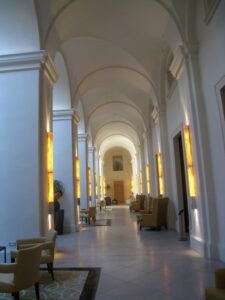 long hallway with white walls and arched ceiling