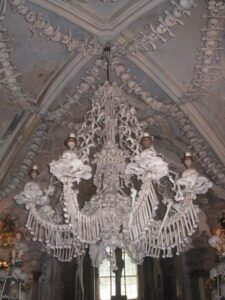 a chandelier with skeletons of people