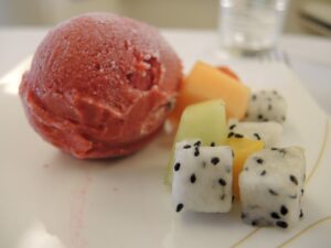 a scoop of fruit and ice cream