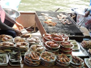 a woman cooking seafood on a boat