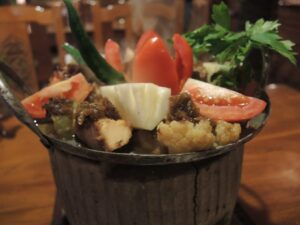 a bucket of food with vegetables