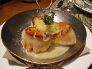 a pan of scallops with sauce