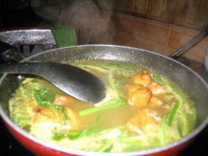 a pot of soup with a ladle