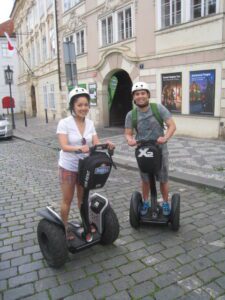 a man and woman riding on segways
