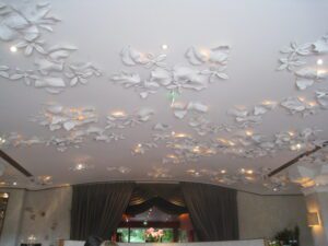 a white ceiling with flowers on it