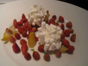 a plate of food with strawberries and marshmallows
