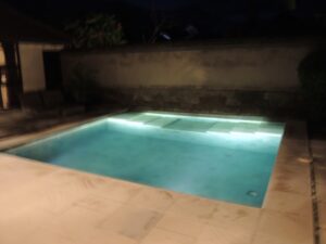 a pool with lights on the side