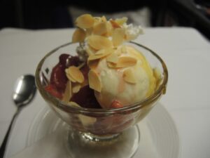 a bowl of ice cream with almond flakes