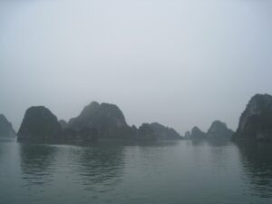 a body of water with mountains in the background with Ha Long Bay in the background