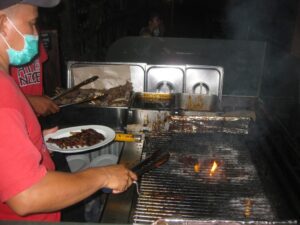 a man cooking food on a grill