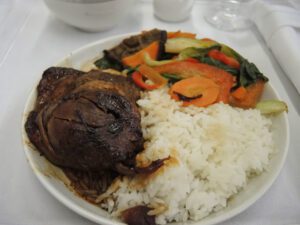a plate of food with meat and rice