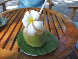 a coconut with a straw on a table