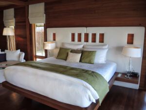 a bed with white and green pillows