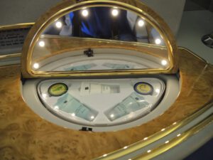 a mirror with a circular object with lights
