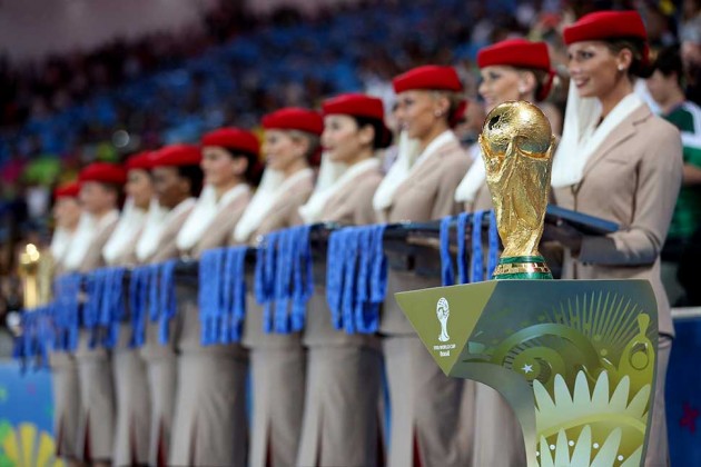 a group of women wearing red hats and a trophy