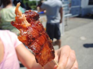a hand holding a piece of meat