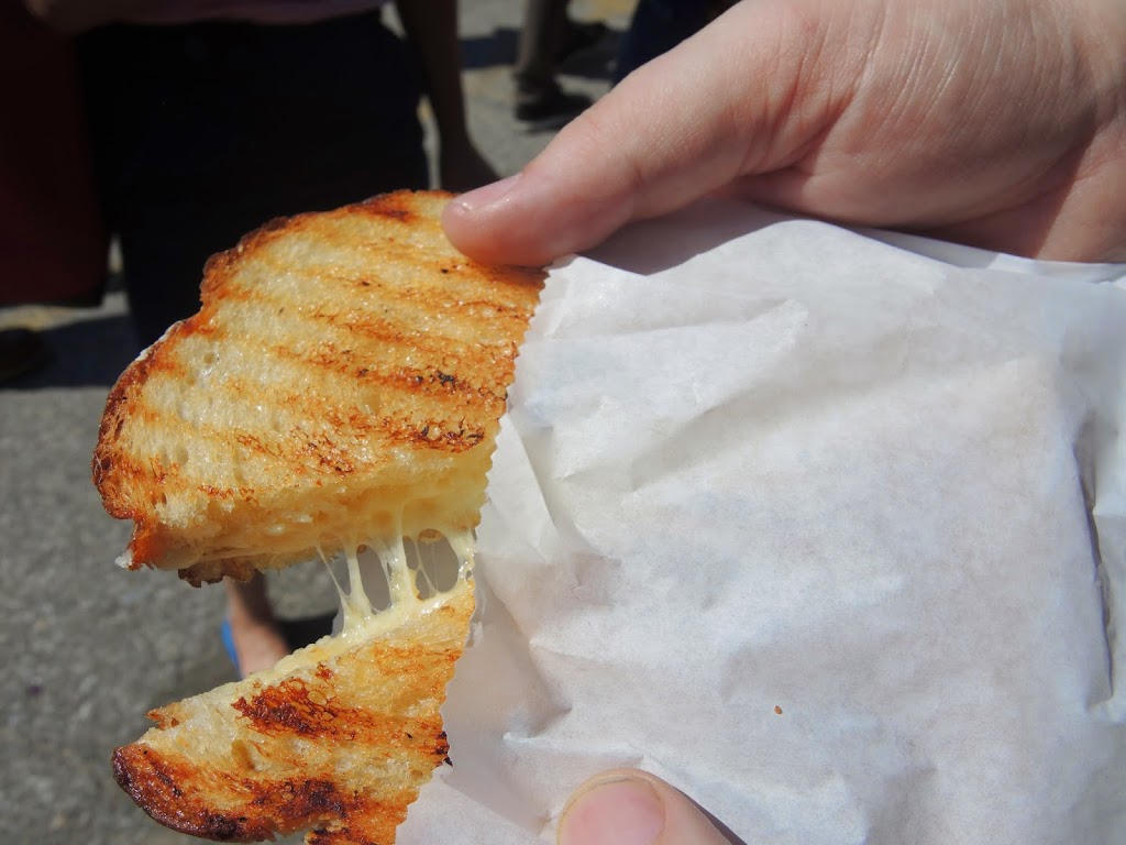 a person holding a grilled sandwich