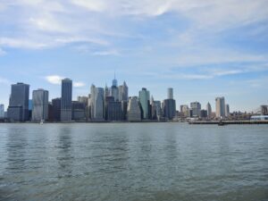 a city skyline with a body of water