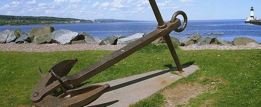 a large anchor on a grassy area
