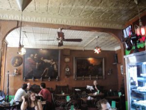a group of people sitting at tables in a restaurant