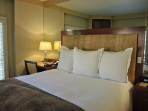 a bed with white pillows and a brown headboard