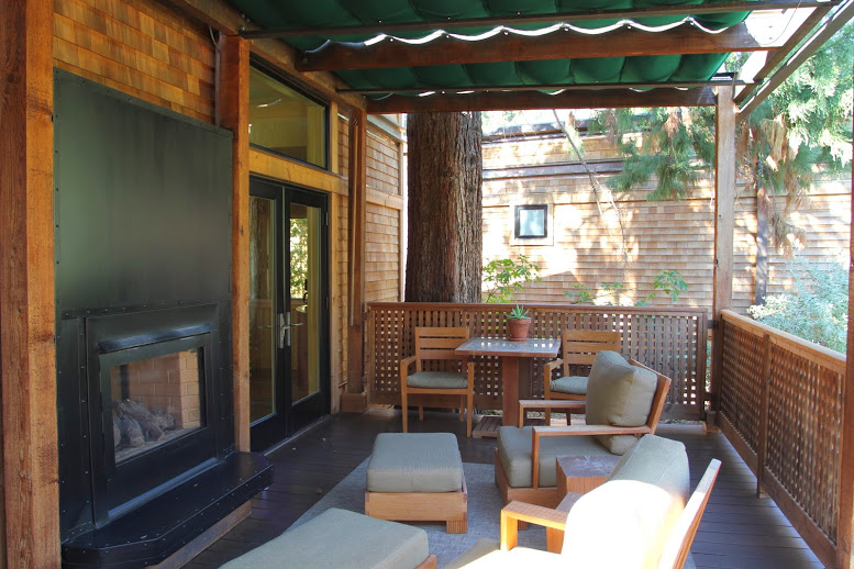 a patio with a fireplace and furniture