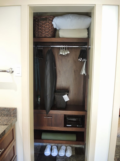 a closet with clothes and towels