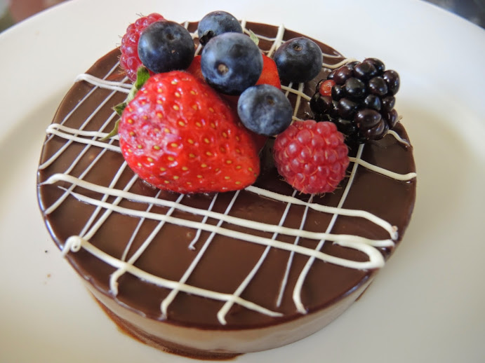 a chocolate cake with berries on top