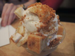 a bowl of ice cream with crumbles and bananas