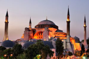 a large building with a dome and towers with Hagia Sophia in the background