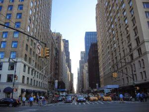 a city street with many tall buildings and cars