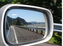 a side view mirror of a road
