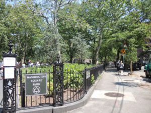 a black fence with a sign on it