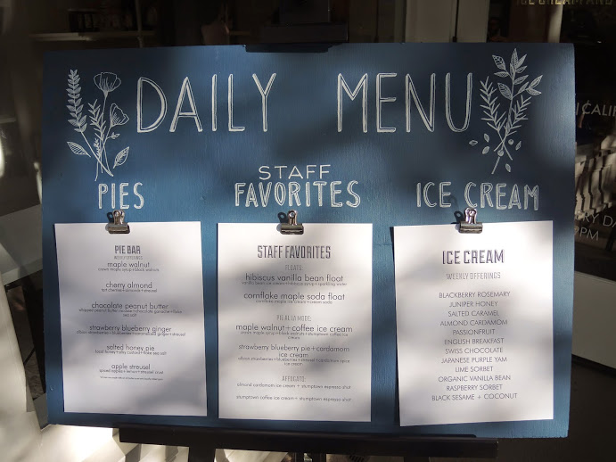 a menu board with white paper on it