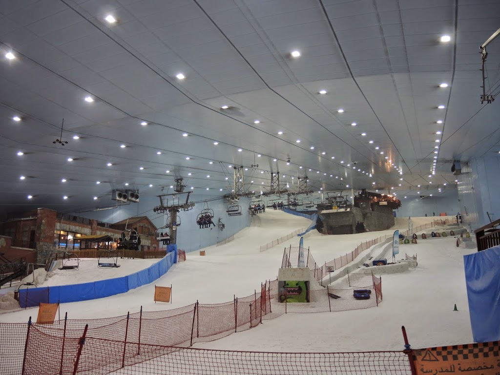 a indoor snow covered area with a ski lift and a cable car