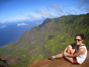 a woman sitting on a mountain