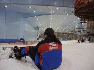 a woman sitting on the snow