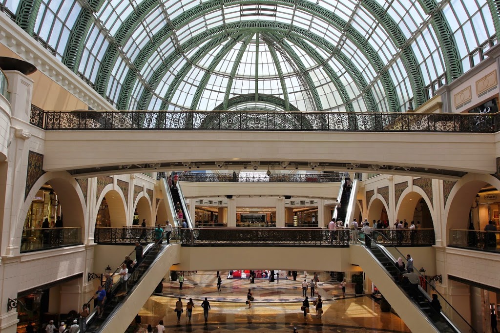 a large building with many escalators and people walking