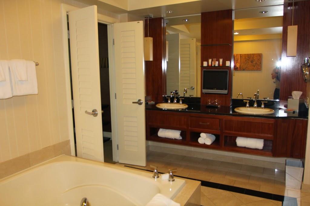 a bathroom with a tub and double sink