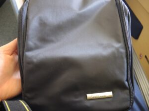 a black backpack with a silver logo