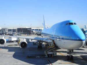 a blue and white airplane at an airport