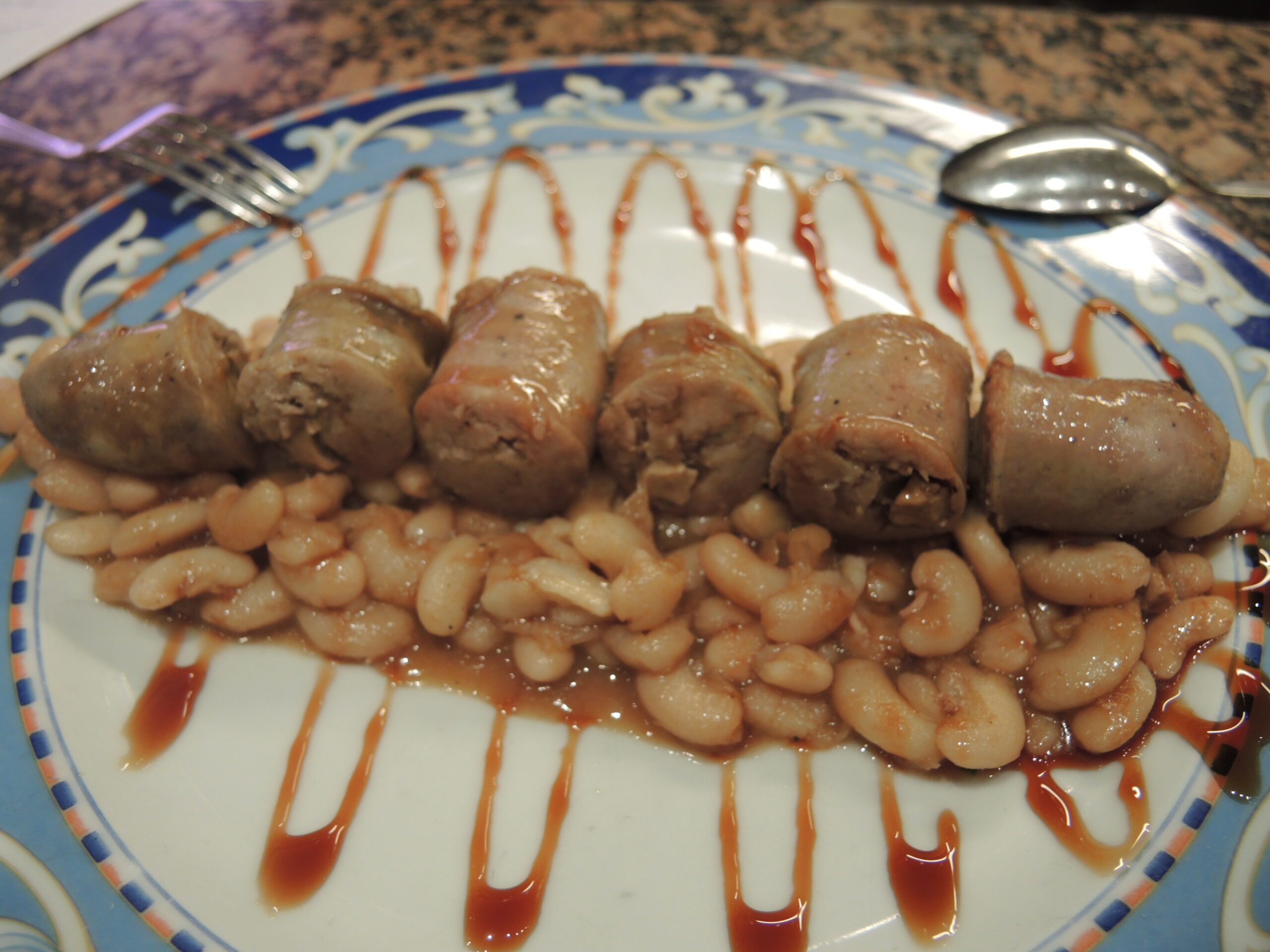 a plate of food with beans and meat