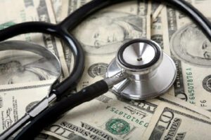 a stethoscope on top of money