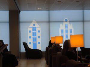 a group of people sitting in a room with a projector screen