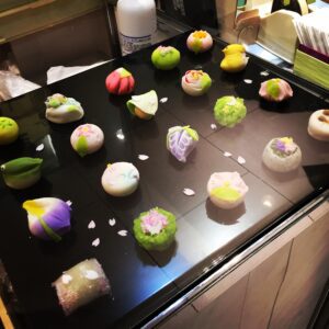 a group of colorful desserts on a black surface