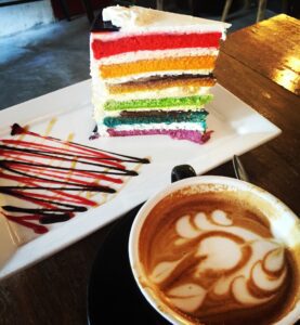 a plate with a slice of cake and a cup of coffee