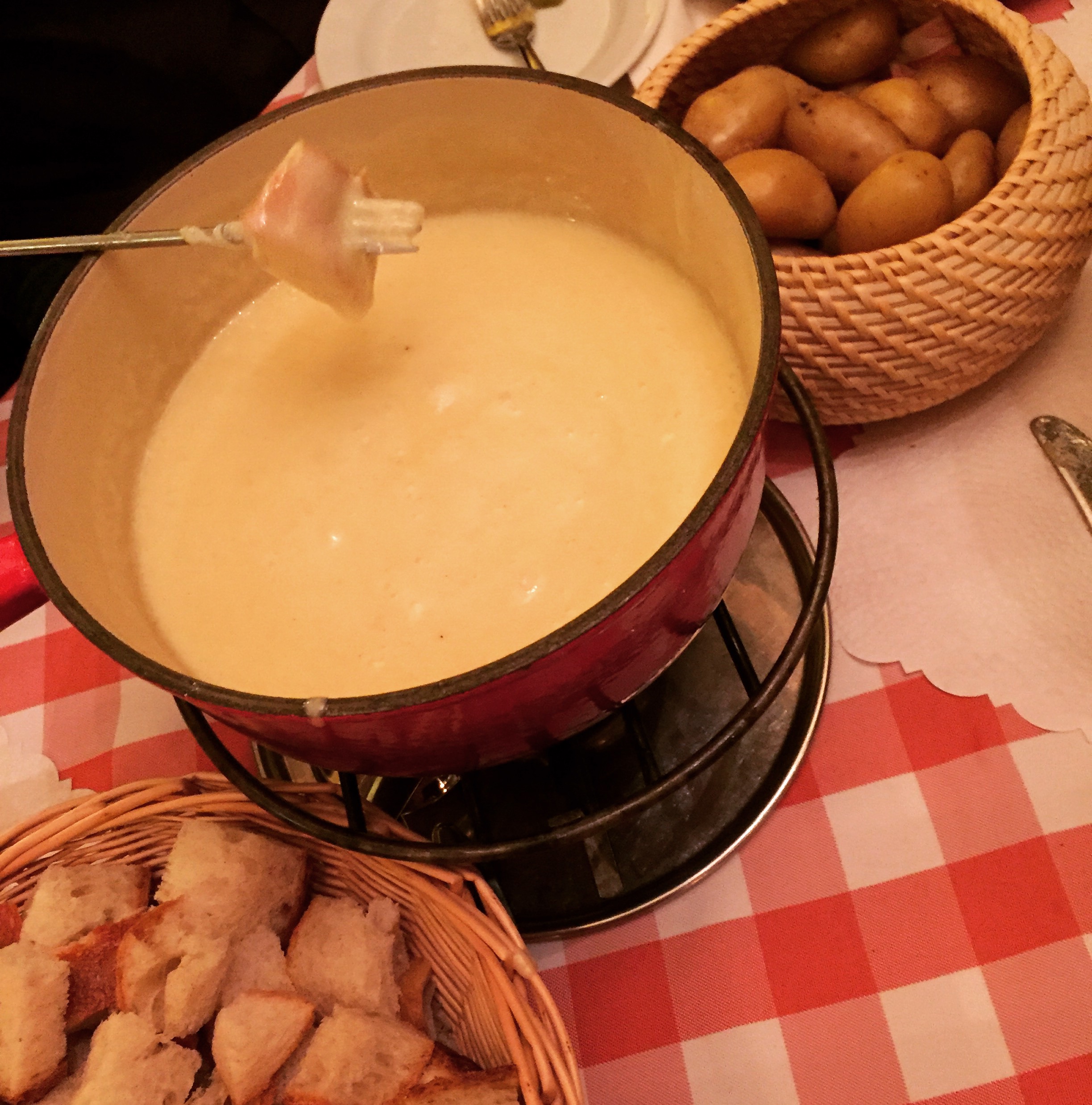 a pot of fondue with a fork in it