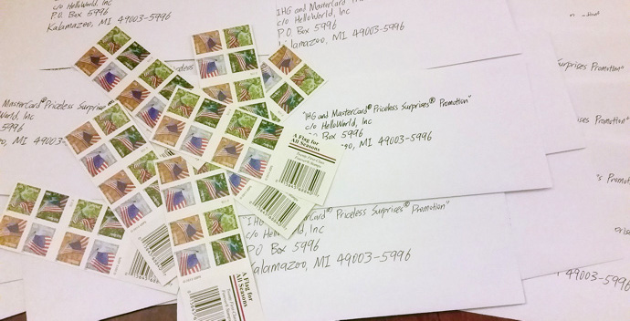 a pile of postage stamps on a pile of white paper