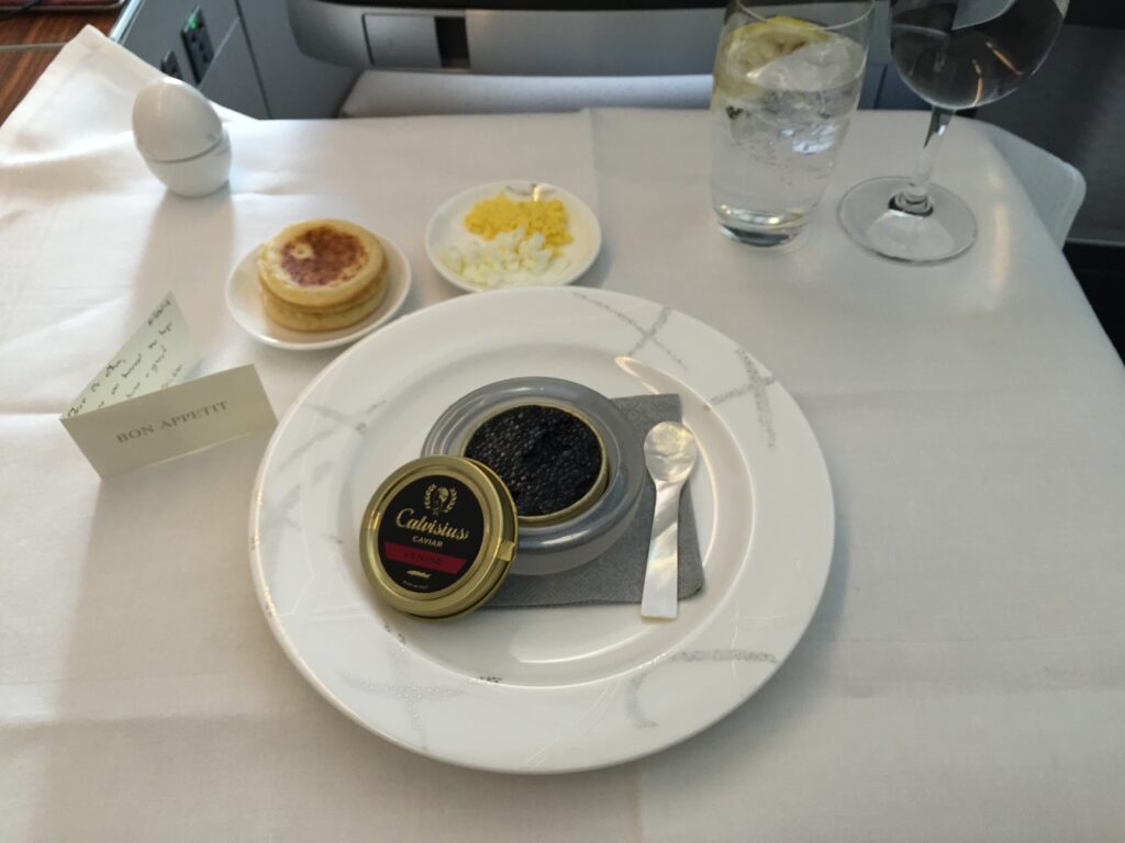 cathay pacific first class hong kong to new york dinner table note caviar
