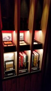 a shelf with books and a box